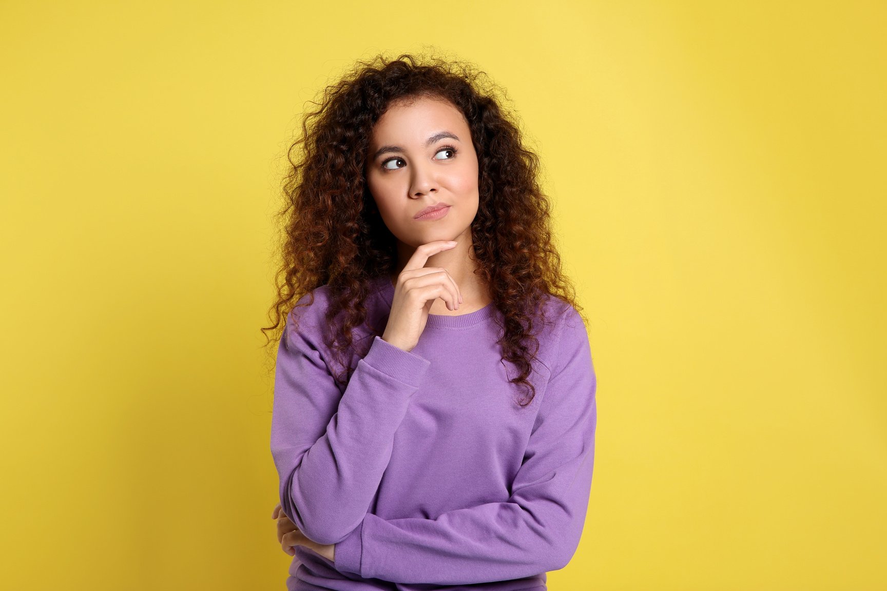 Pensive African-American Woman on Yellow Background. Thinking Ab